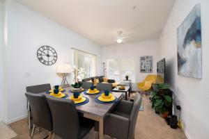 a dining room and living room with a table and chairs at Pet Friendly House in Resort Style Condo Near Disney, 4 Pools, Hot Tub & Gym in Kissimmee