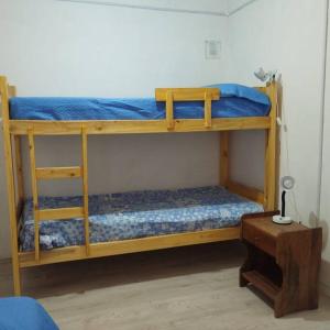 a couple of bunk beds in a room at Los Piros Alojamiento in Esquel