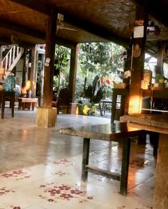 a wooden bench sitting inside of a building at Champalao The Villa in Vang Vieng