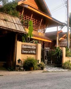 a building with a sign in front of it at Champalao The Villa in Vang Vieng