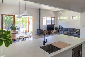 a kitchen and living room with a sink and a couch at The Cottage on Market in Mudgee