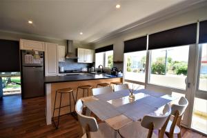 a kitchen and dining room with a table and chairs at Esplanade Sophistication Close To Town And Inlet Beach in Inverloch