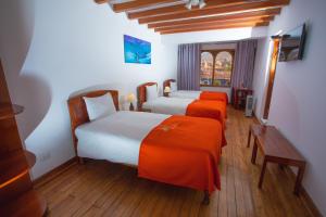 Postel nebo postele na pokoji v ubytování Centenario Inn