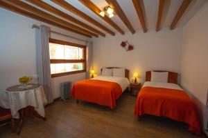 Postel nebo postele na pokoji v ubytování Centenario Inn