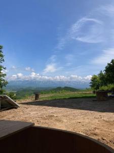 a view of a field with mountains in the distance at はるの空 in Biei +16 photos