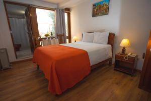 Postel nebo postele na pokoji v ubytování Centenario Inn