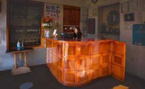 a woman sitting at a counter in a bar at Centenario Inn in Cusco