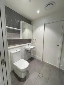 a bathroom with a toilet and a sink at New Modern apartment next to Westfield Chermside in Brisbane