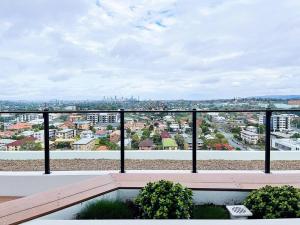 a balcony with a view of a city at New Modern apartment next to Westfield Chermside in Brisbane
