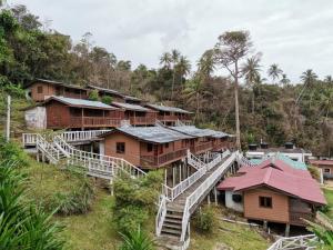 a group of houses on a hill with trees at Long Beach Garden in Kampung Kuala Besut