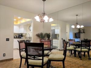 a dining room and kitchen with a table and chairs at Upscale 2Bed 2Bath Condo Prime Location WiFi Pools Kitchen Security in Palm Springs