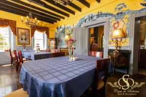 a dining room with a table with blue table cloth at Casa De Solana Bed and Breakfast in Saint Augustine