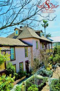 a large house with a garden in front of it at Casa De Solana Bed and Breakfast in St. Augustine