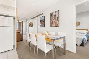 a kitchen and dining room with a table and chairs at Bayvista at Silverwater in San Remo