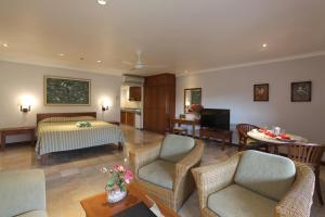 a hotel room with a bed and a living room at Peninsula Beach Resort in Nusa Dua