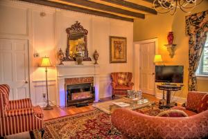 a living room with a fireplace and a tv at Casa De Solana Bed and Breakfast in Saint Augustine