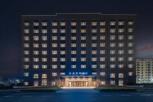 a rendering of a hotel building at night at Joy Fall Hotel in Jiaozhou