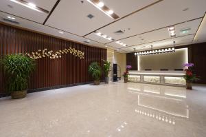 a lobby with a waiting area with potted plants at Joy Fall Hotel in Jiaoxian
