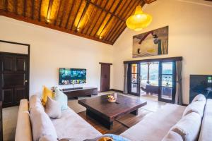 a living room with a couch and a coffee table at Patal Kikian Villa in Sidemen