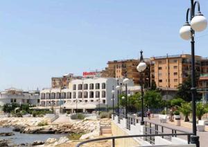 a city with buildings and a river and street lights at Hotel Panorama Del Golfo in Manfredonia