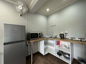 a kitchen with a counter and a refrigerator at Halleria Self Catering in White River