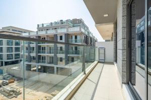 an empty balcony of a building with glass windows at Primestay - Prime Views Meydan 1BR in Dubai