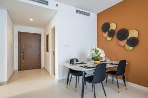 a dining room with a table and chairs at Primestay - Prime Views 1BR in Al Meydan in Dubai