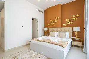 a bedroom with a large white bed with brown walls at Primestay - Prime Views 1BR in Al Meydan in Dubai
