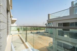 a glass balcony with a view of a building at Primestay - 1BR in Prime Views in Al Meydan in Dubai