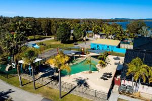 an aerial view of a pool at a resort at Lakeside Forster Holiday Park and Village in Forster