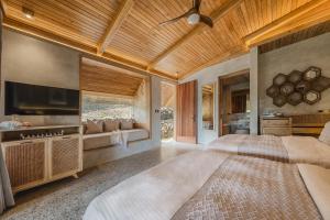 a bedroom with two beds and a flat screen tv at Manami Resort 