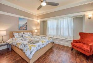 a bedroom with a bed and a chair and a window at 2 King Beds! Fantastic Stylish Bungalow home! in Fresno