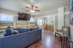 a living room with a blue couch and a ceiling fan at 2 King Beds! Fantastic Stylish Bungalow home! in Fresno