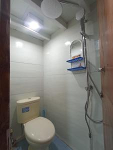 a bathroom with a toilet and a shower at Family Labuan Bajo in Labuan Bajo