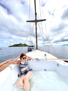 a woman sitting on a boat in the water at Family Labuan Bajo in Labuan Bajo