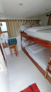 a bedroom with two bunk beds and a table at Family Labuan Bajo in Labuan Bajo
