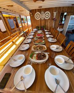a long table with plates of food on it at Family Labuan Bajo in Labuan Bajo