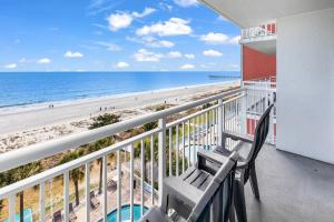 a balcony with two chairs and a view of the beach at Oceanfront Atlantica 2BR Condo w Balcony in Myrtle Beach