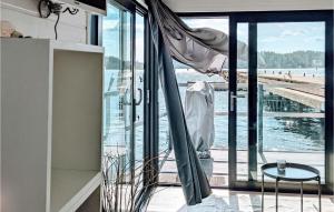 a room with a balcony with a view of the water at Stunning Ship-boat In Blankaholm With Wifi And 1 Bedrooms in Blankaholm