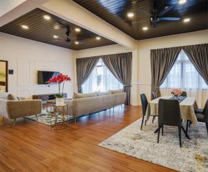 a living room with a couch and a table and chairs at SPRINGHILL RESORT in Cameron Highlands