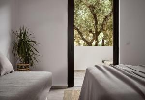 a bedroom with a bed and a large window at Sanpiero Island in Zakynthos Town