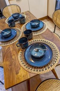 a wooden table with blue bowls and plates on it at Superb 2p of standing, all comfort, perfect locati in Nice