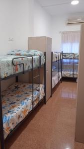 a dorm room with three bunk beds in it at Hostel Rural David Broncano in Orcera