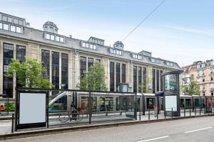 a bus stop in front of a large building at Appart'City Confort Strasbourg Centre in Strasbourg