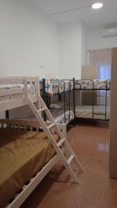a room with two bunk beds in a room at Hostel Rural David Broncano in Orcera