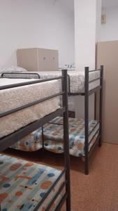 a group of bunk beds in a room at Hostel Rural David Broncano in Orcera