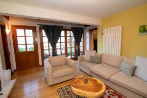 a living room with a couch and a table at Villa Rina Deluxe and Cottage in Porto Ceresio +32 photos