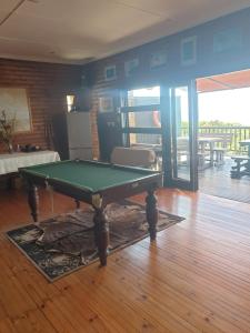 a living room with a pool table in a room at Deep Blue Guest House in Amanzimtoti