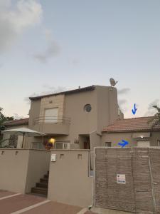 a house with a fence in front of it at studio by the sea in Ashdod