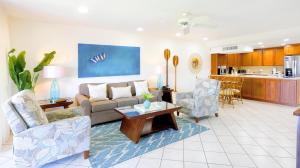 a living room with a couch and chairs and a table at Maui Eldorado B200-Large lanai w/ocean/golf course views in Lahaina